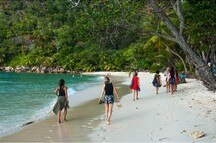Women enjoying a long stroll on the picturesque beach Women enjoying a long stroll on the picturesque beach